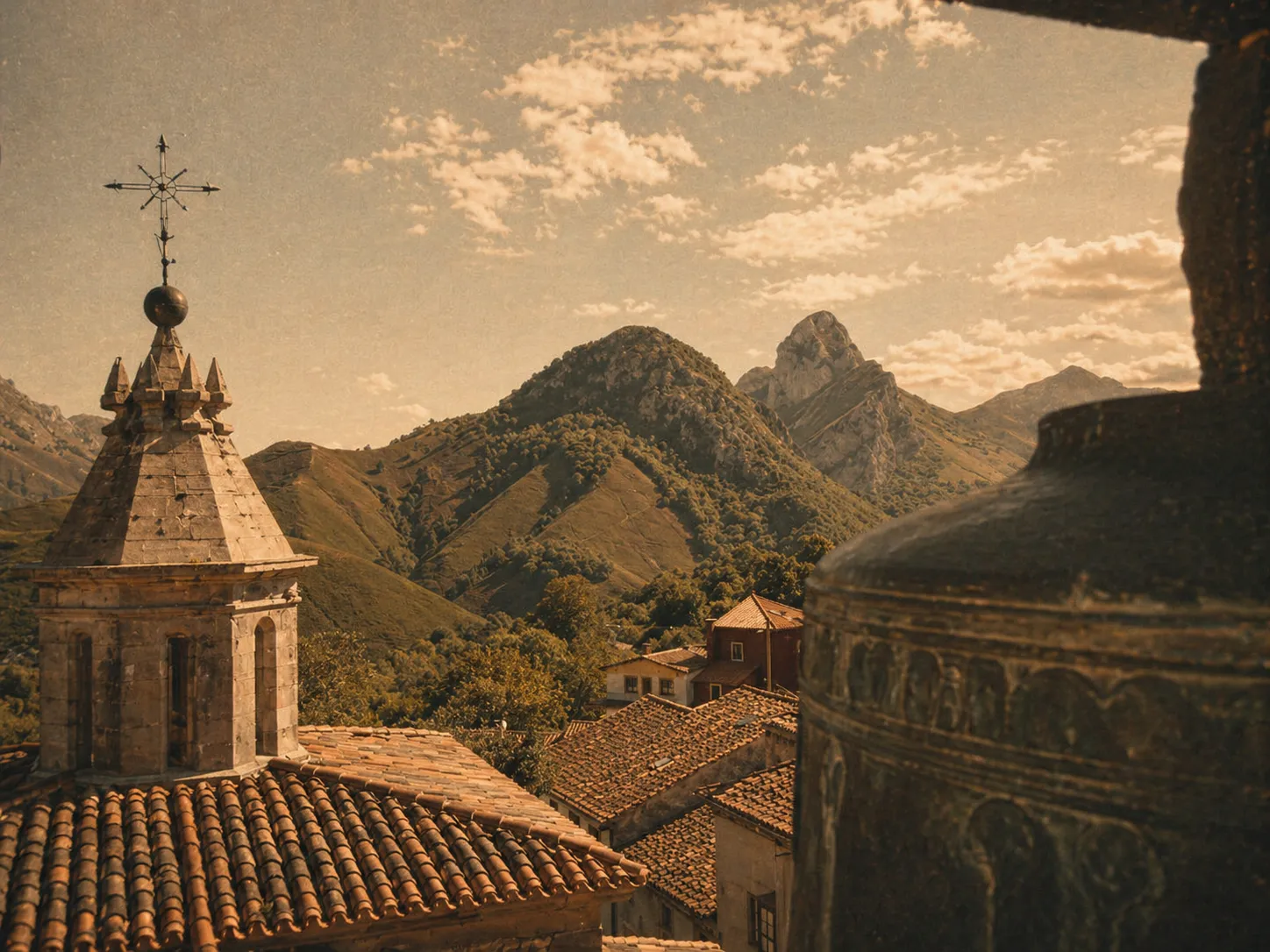 Vista del campanario de Alles con montañas al fondo